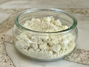 Blanched almond flour in a glass bowl.