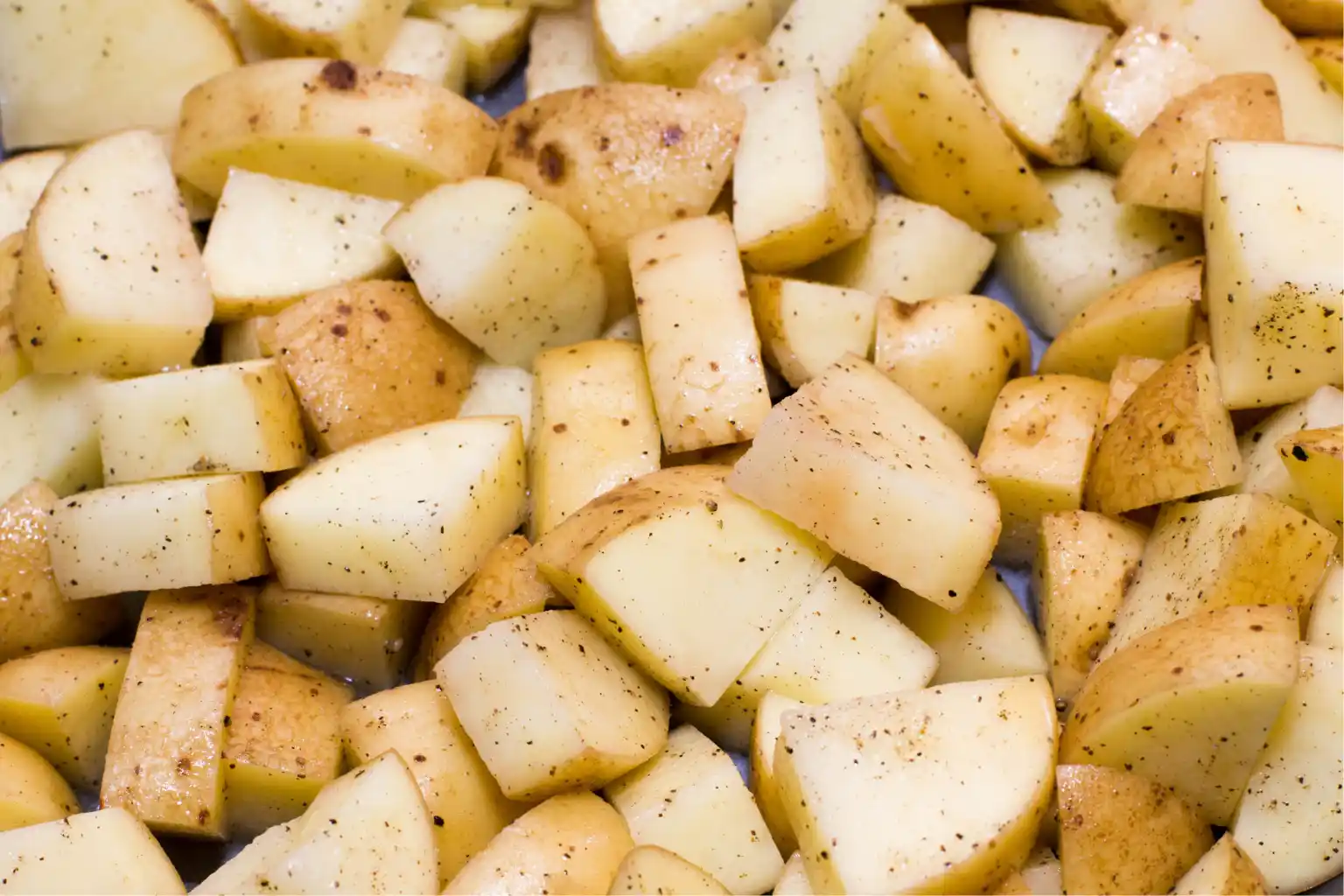 Crispy roasted potato recipe chopped potatoes with spices on them to show crispy roasted potato recipe